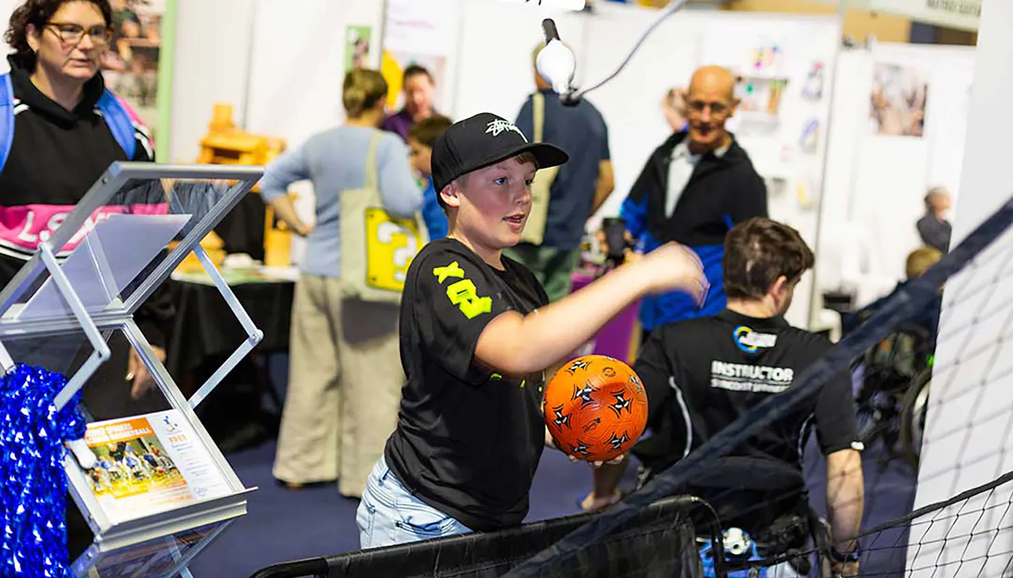 Kids trying basketball at the Education Fair 2023