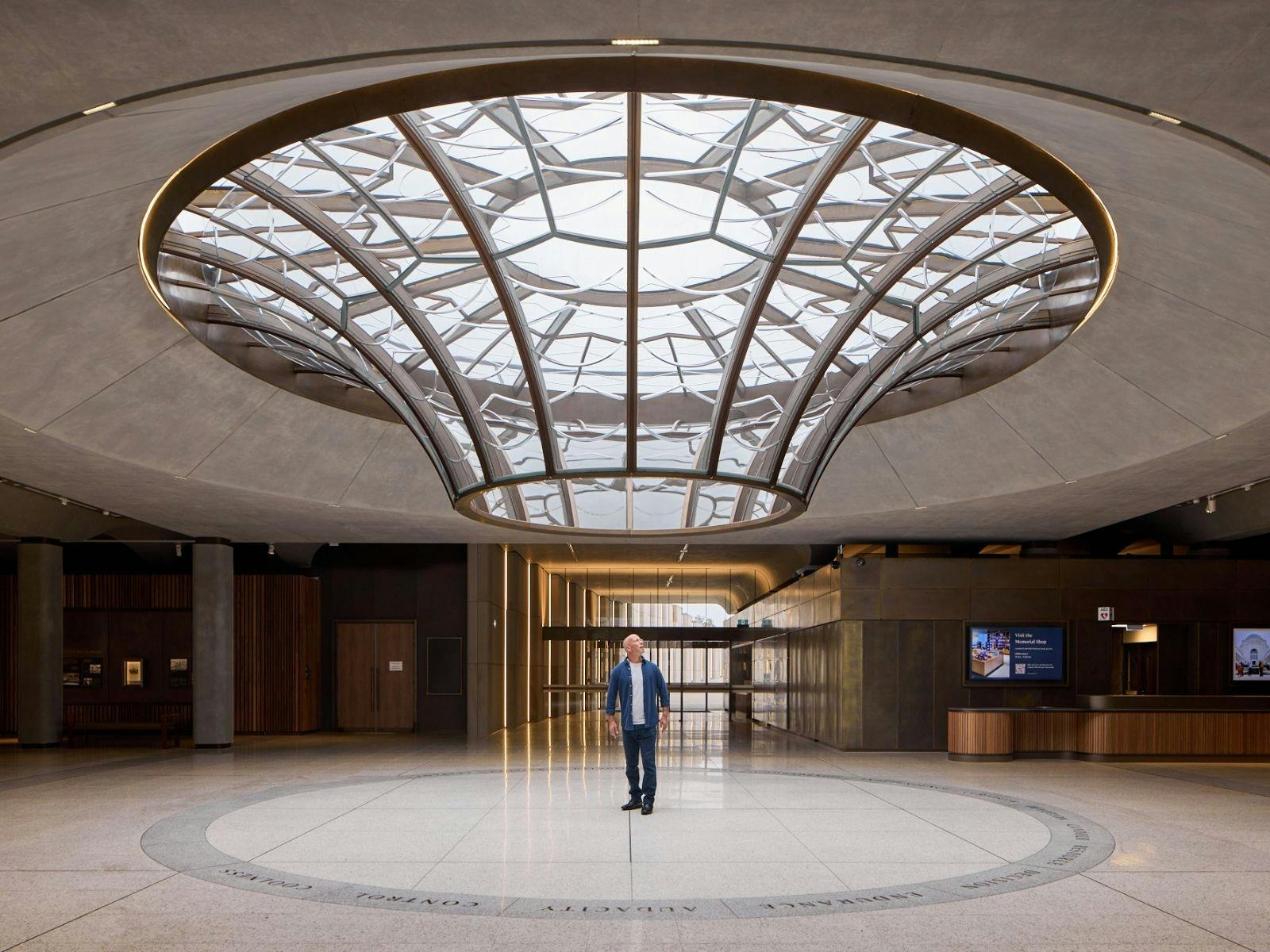 Person standing under the glass Oculus in the Australian War Memorial's Main Entrance foyer