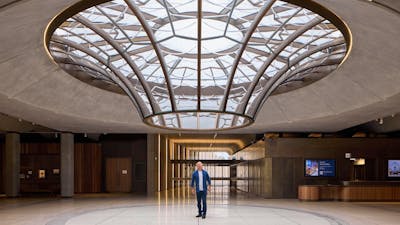 Person standing under the glass Oculus in the Australian War Memorial's Main Entrance foyer