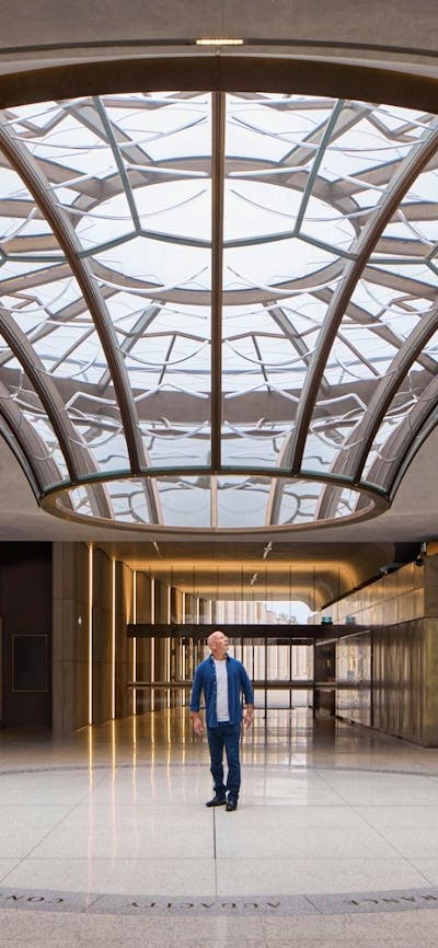 Person standing under the glass Oculus in the Australian War Memorial's Main Entrance foyer