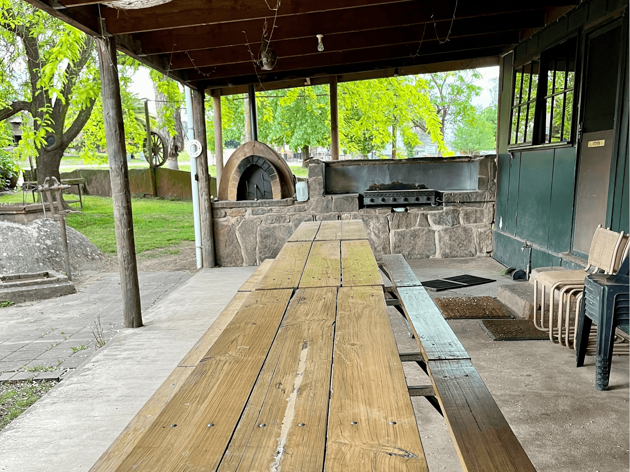 Outdoor dining with a barbecue and pizza oven
