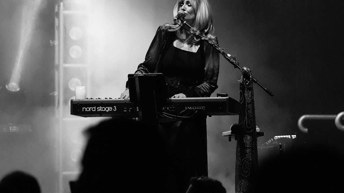 Former Dreams Show members performing Fleetwood Mac hits onstage with full crowd energy.