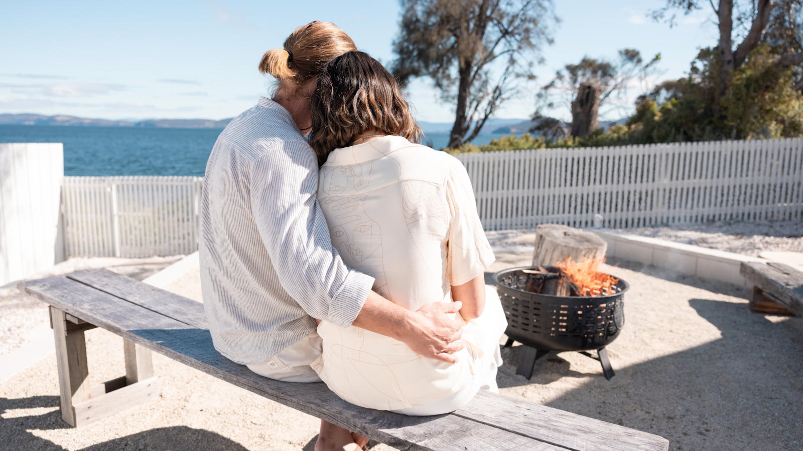 Cozy up by the fire pit with ocean views, perfect for romantic moments