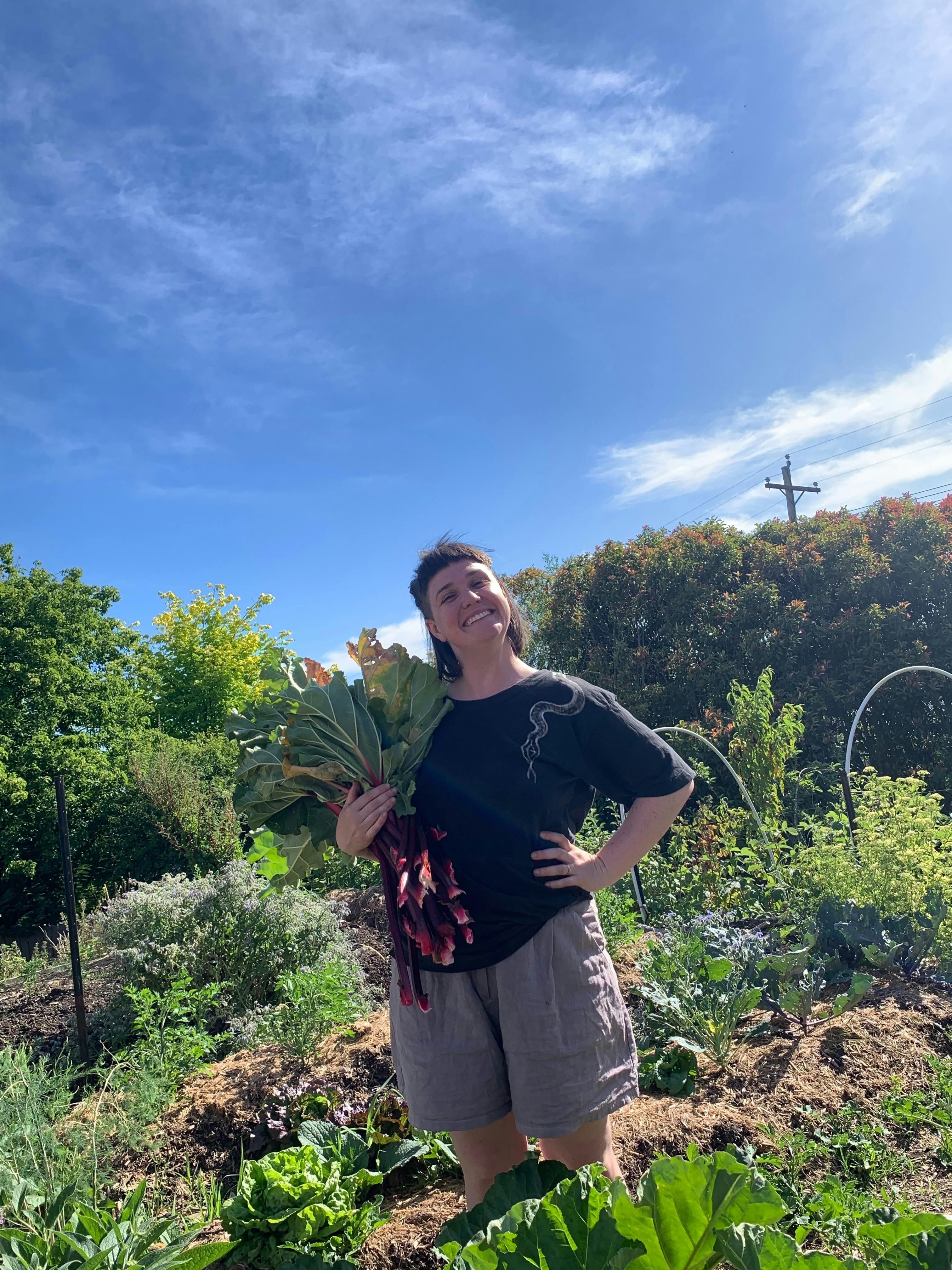 Woman smiling, holding rhuburb