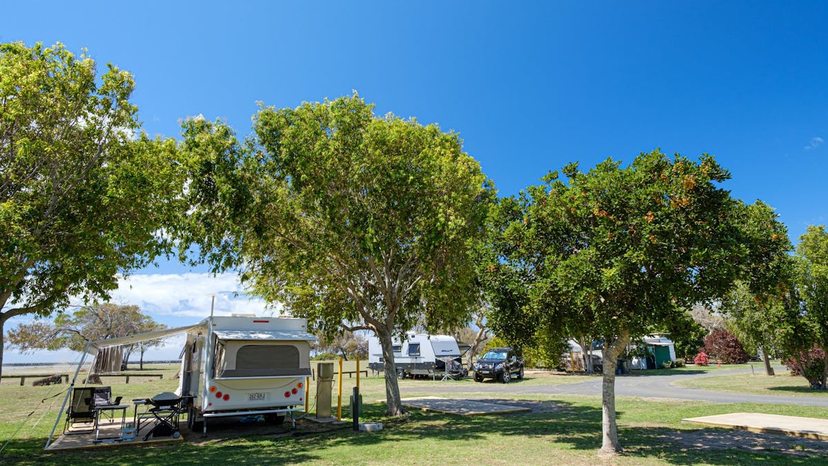Powered Sites with concrete slab and shade trees.