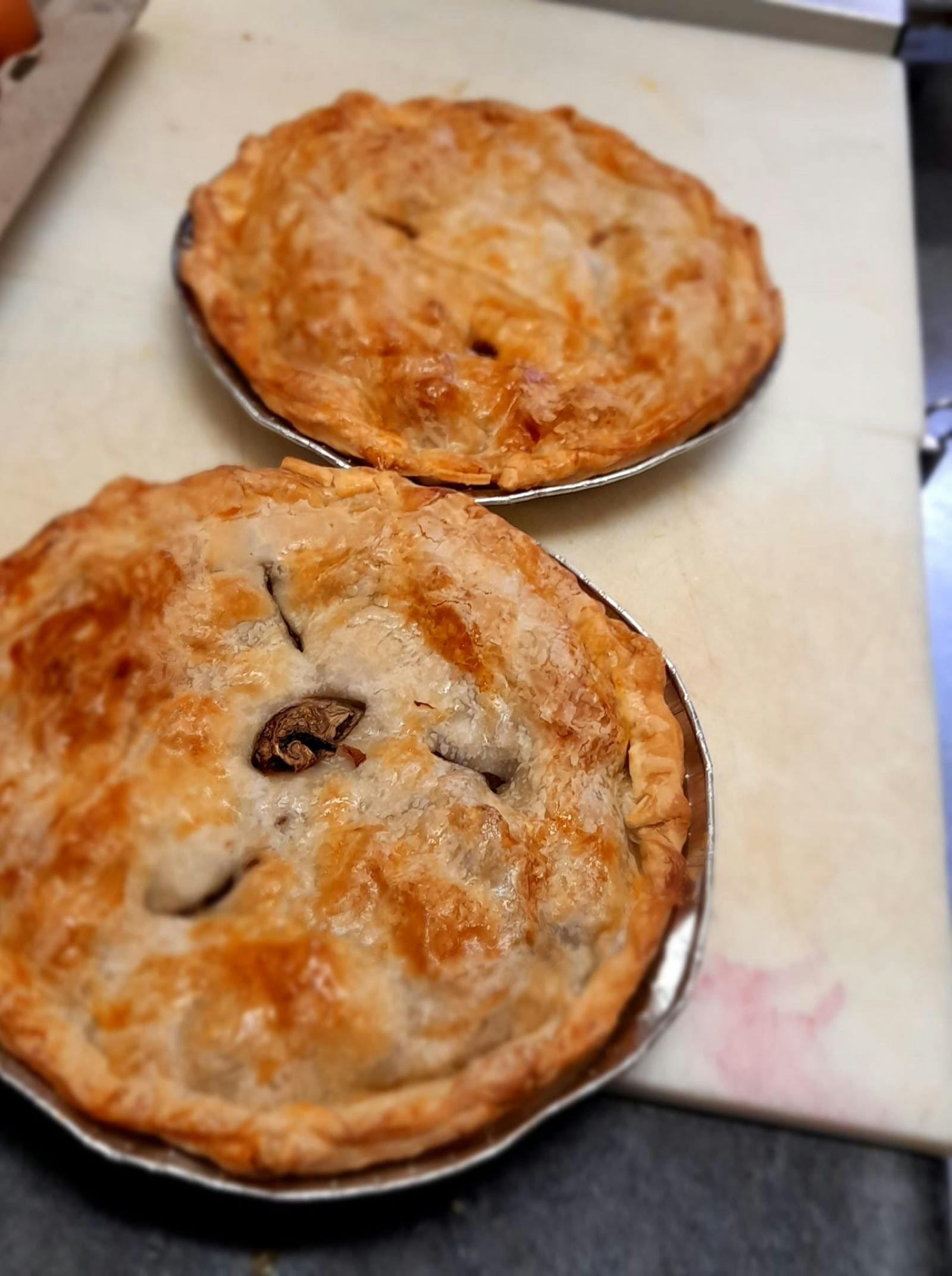 Close up of crispy toasted meat pies.