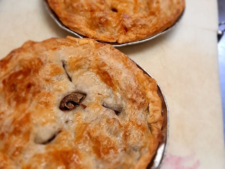 Close up of crispy toasted meat pies.