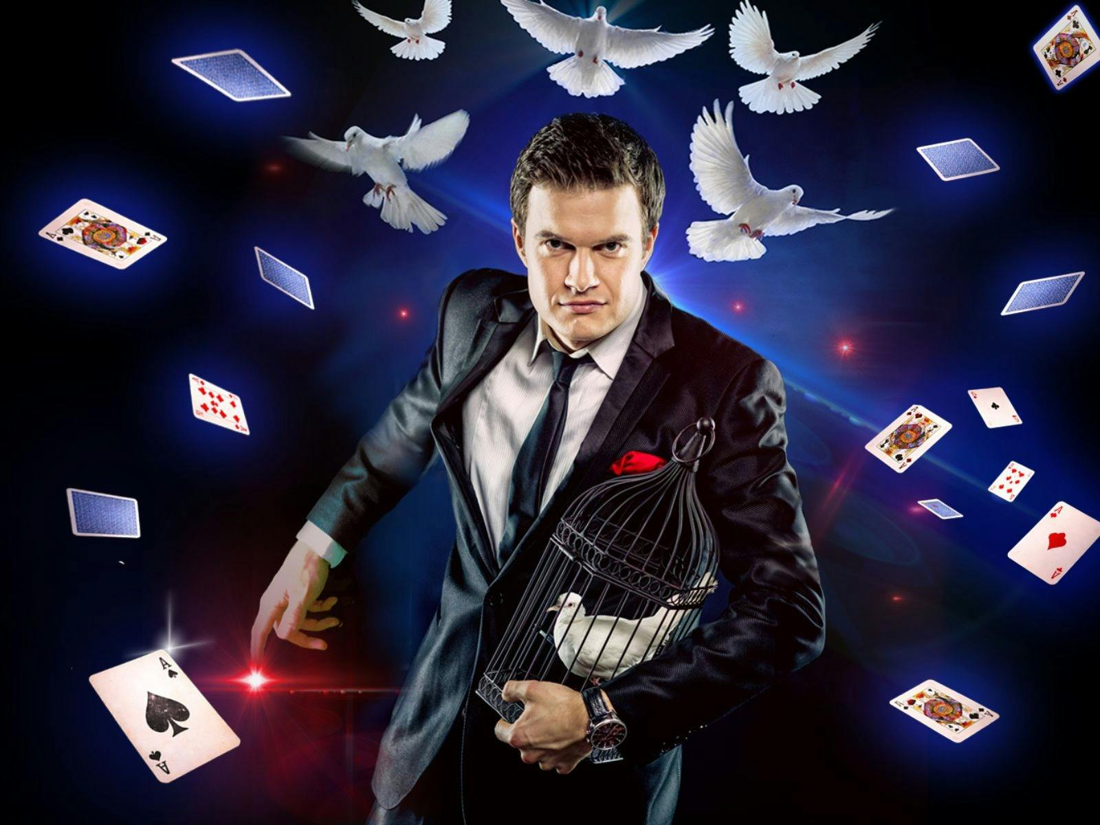 Man in suit and black tie with playing cards and birds flying around him Man in suit and black tie with playing cards and birds flying around him