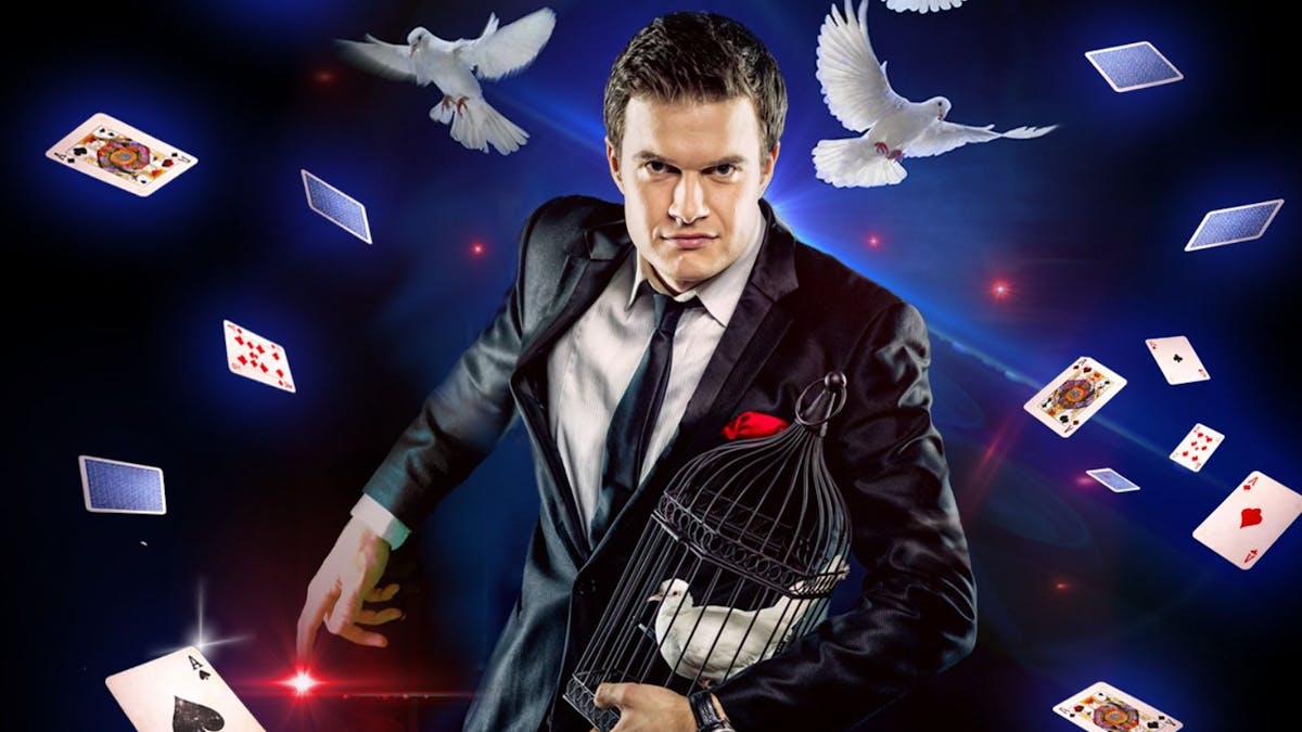 Man in suit and black tie with playing cards and birds flying around him