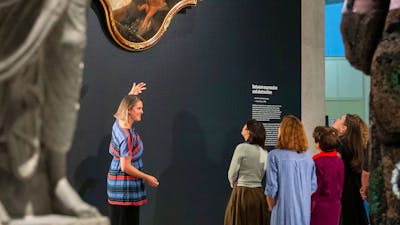 A group of people admiring a painting in a Gallery