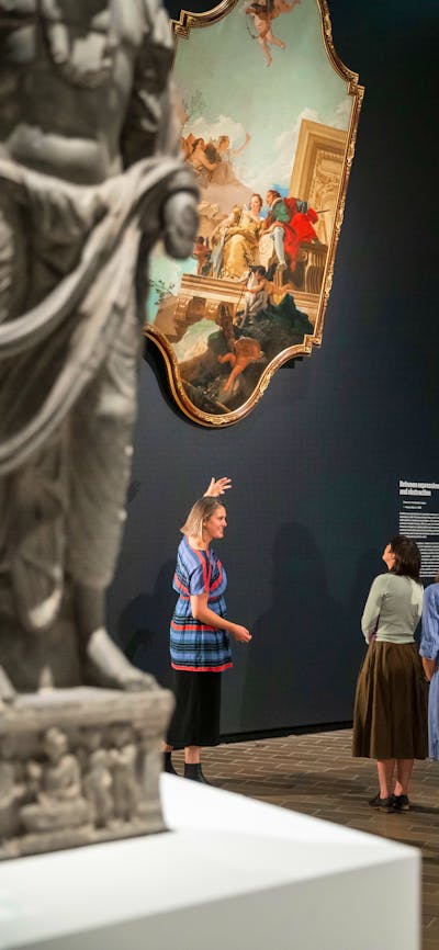A group of people admiring a painting in a Gallery