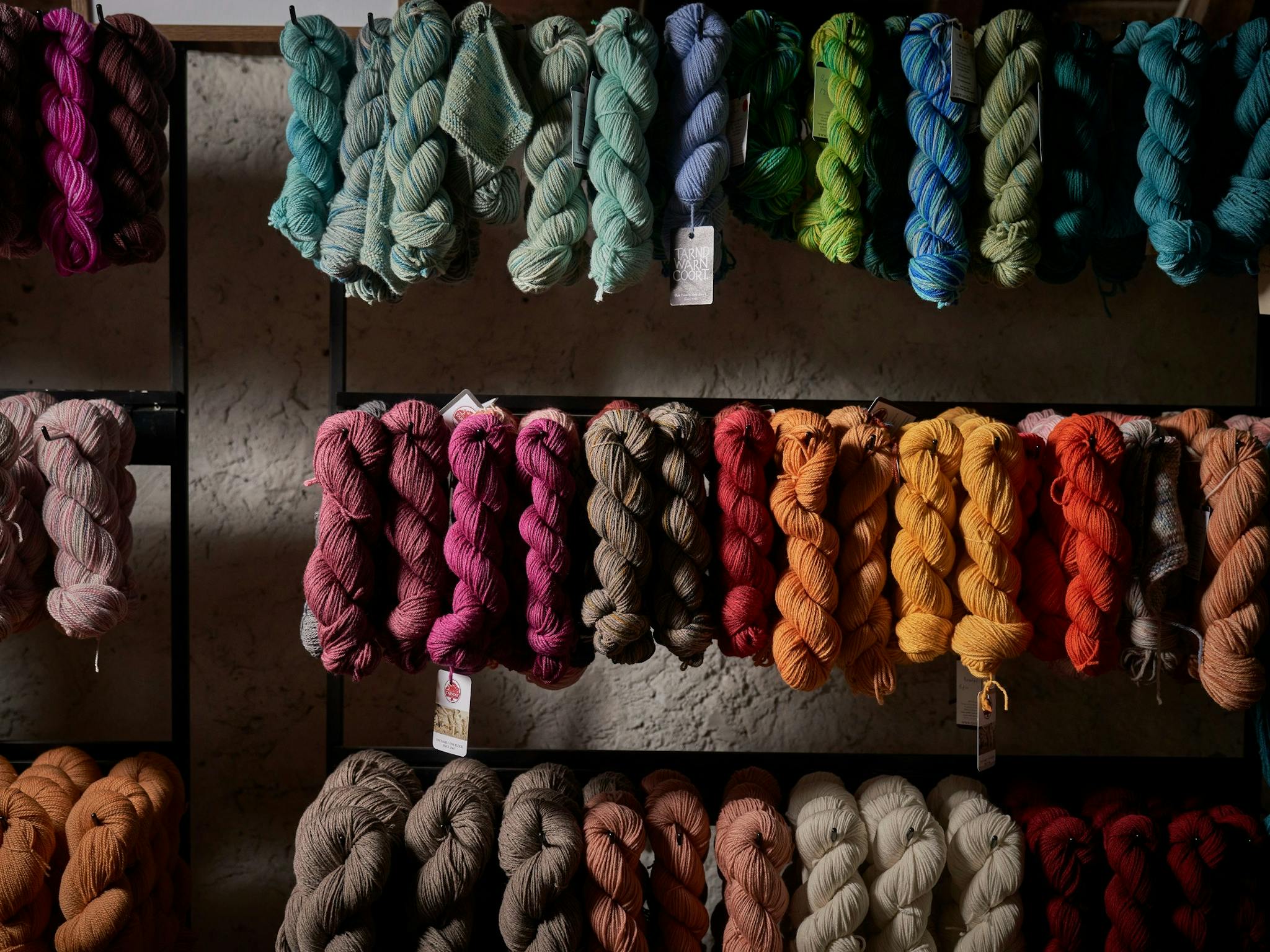 Hand dyed yarn hangs in skeins