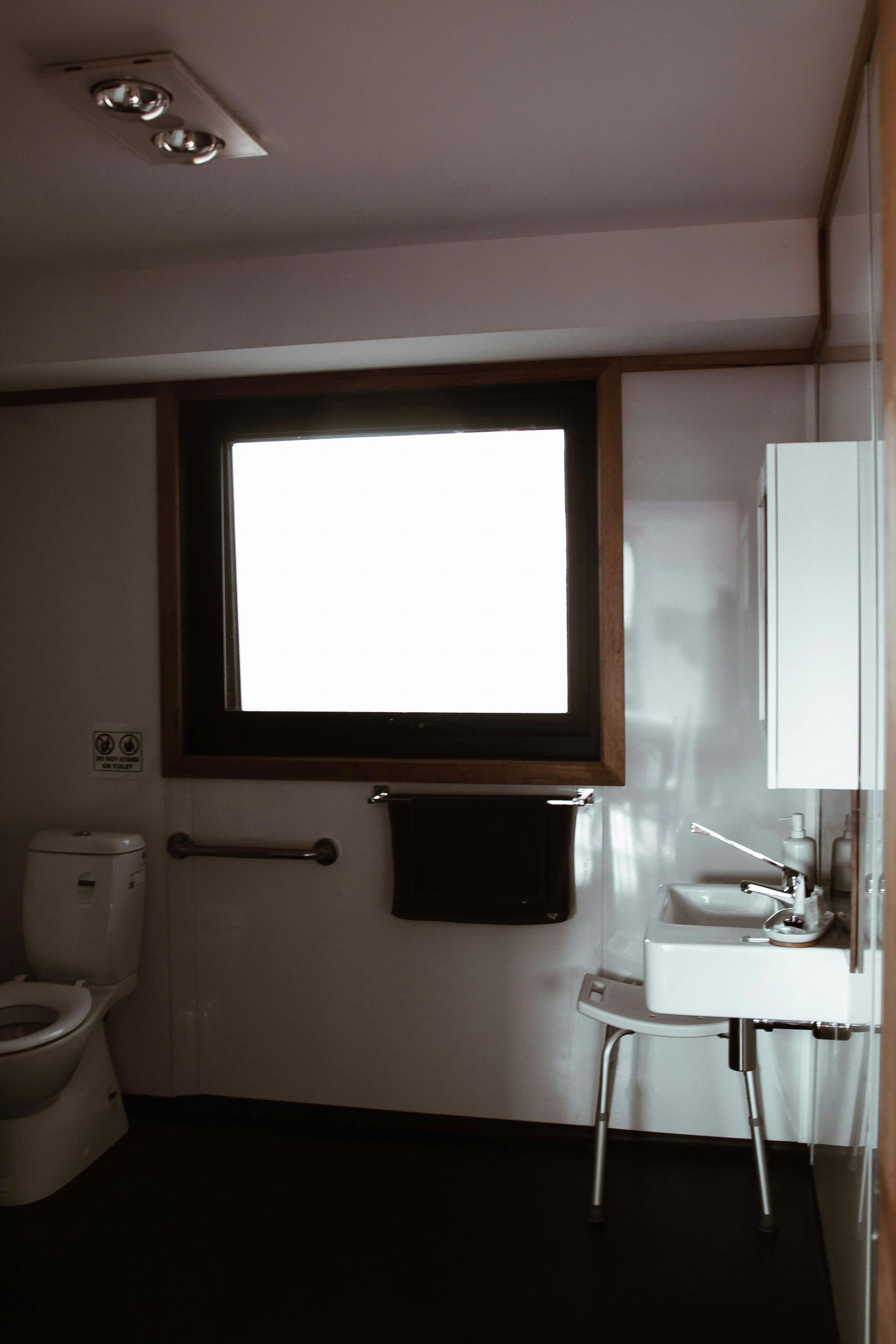 Accessible toilet with grab rails beside the toilet
