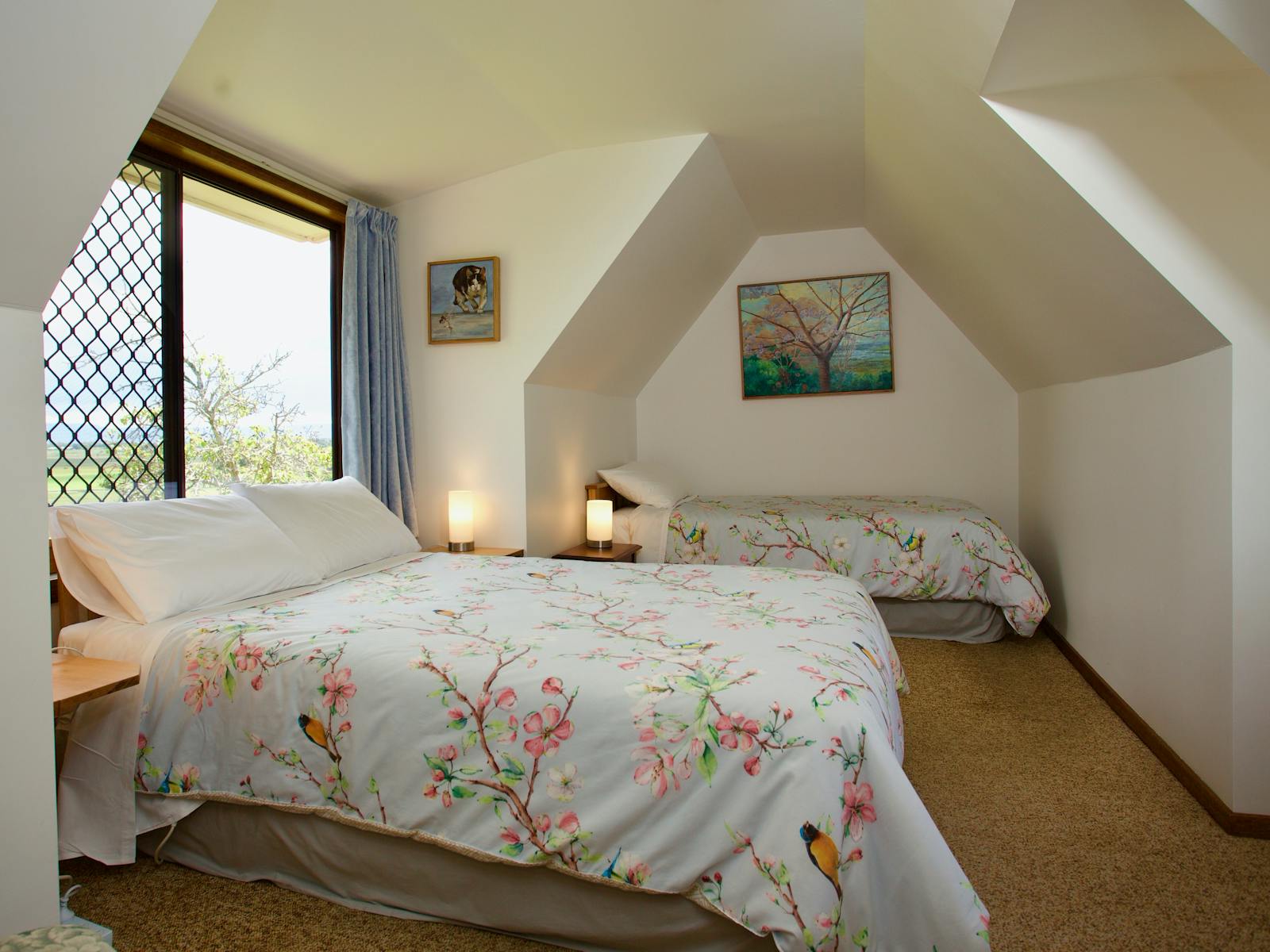 Light and airy attic bedroom with view across to western tiers and into the rose garden. Briar Lane
