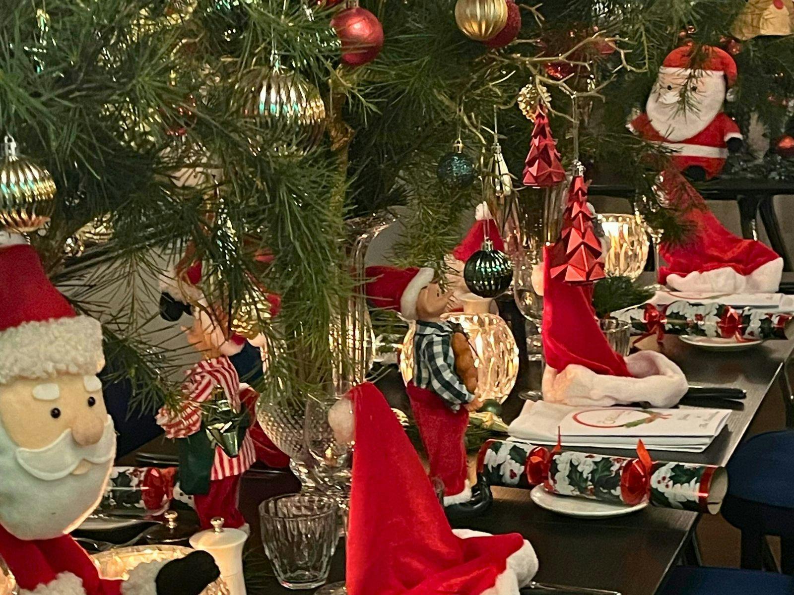 A decorated Christmas lunch table at The Oriana Orange with Santa hats, crackers, and elegant tablew