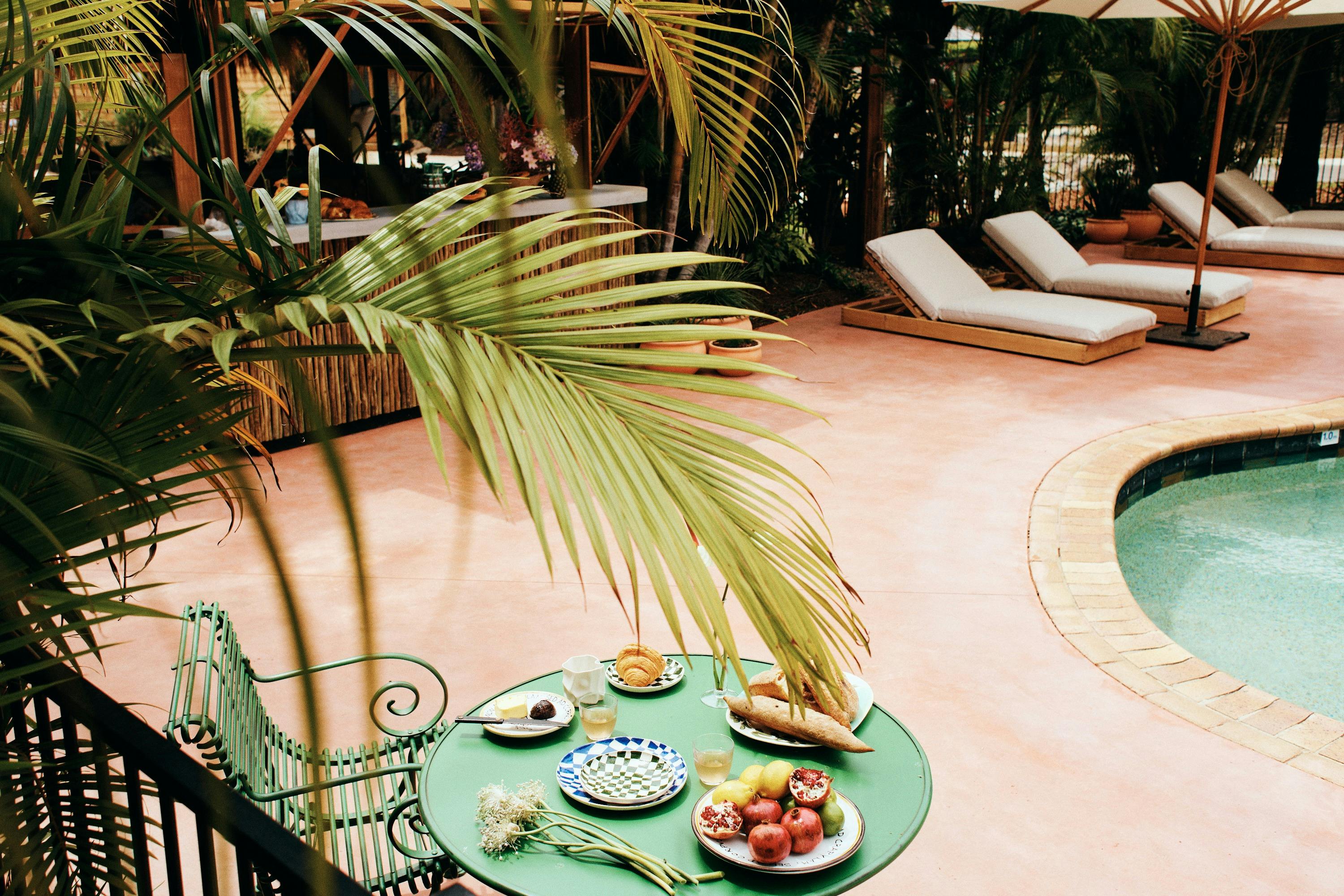 Tropical palm fronds hang over the pool at The Sunseeker, Byron Bay