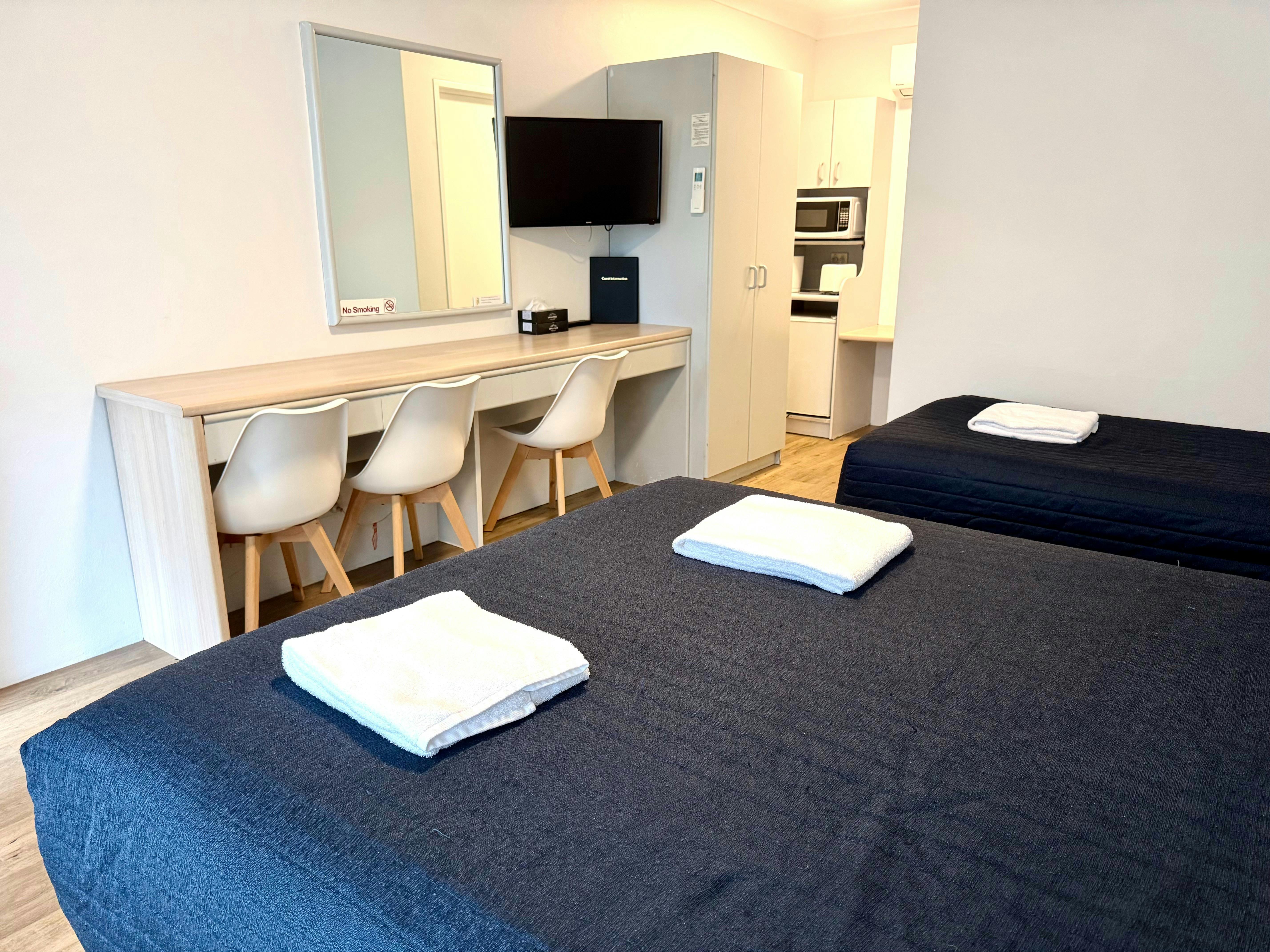 Sutherland Motel Twin or Triple Room with long desk workspace and basic meal making facilities