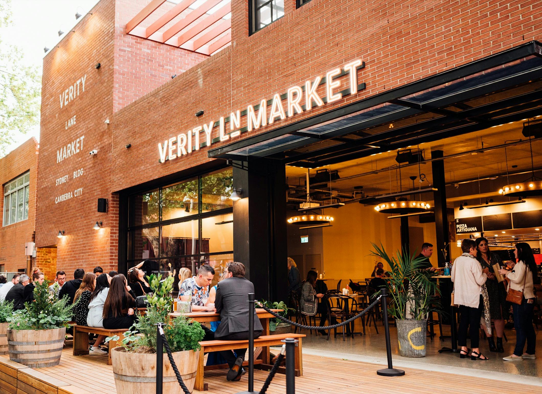 Outdoor deck with people sitting at bar tables