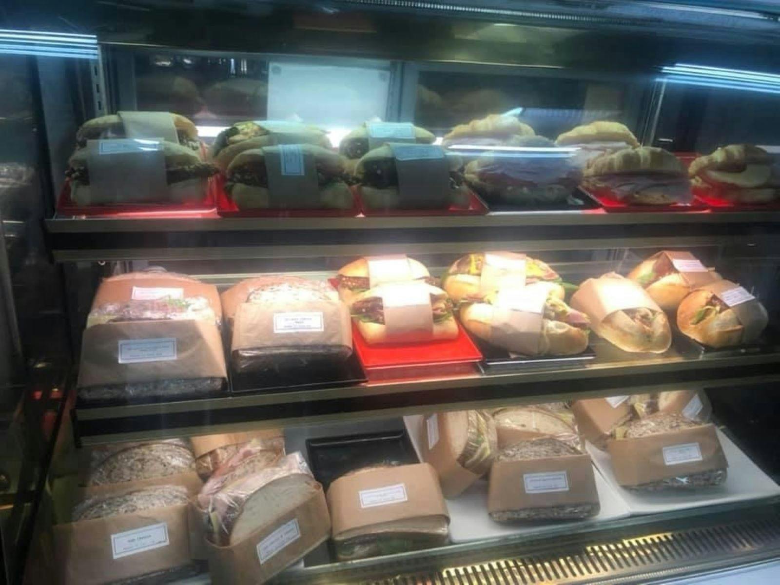 Variety of sandwiches and burgers sitting on display