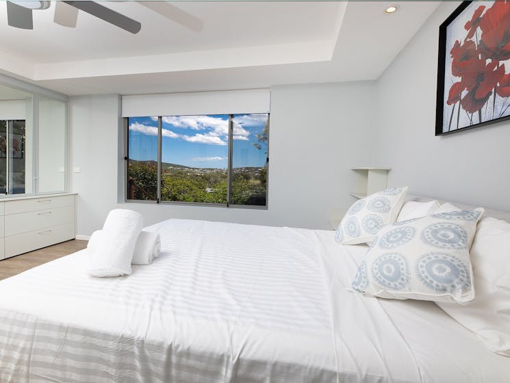 Bedroom with Queen bed, ceiling fan and mountain views