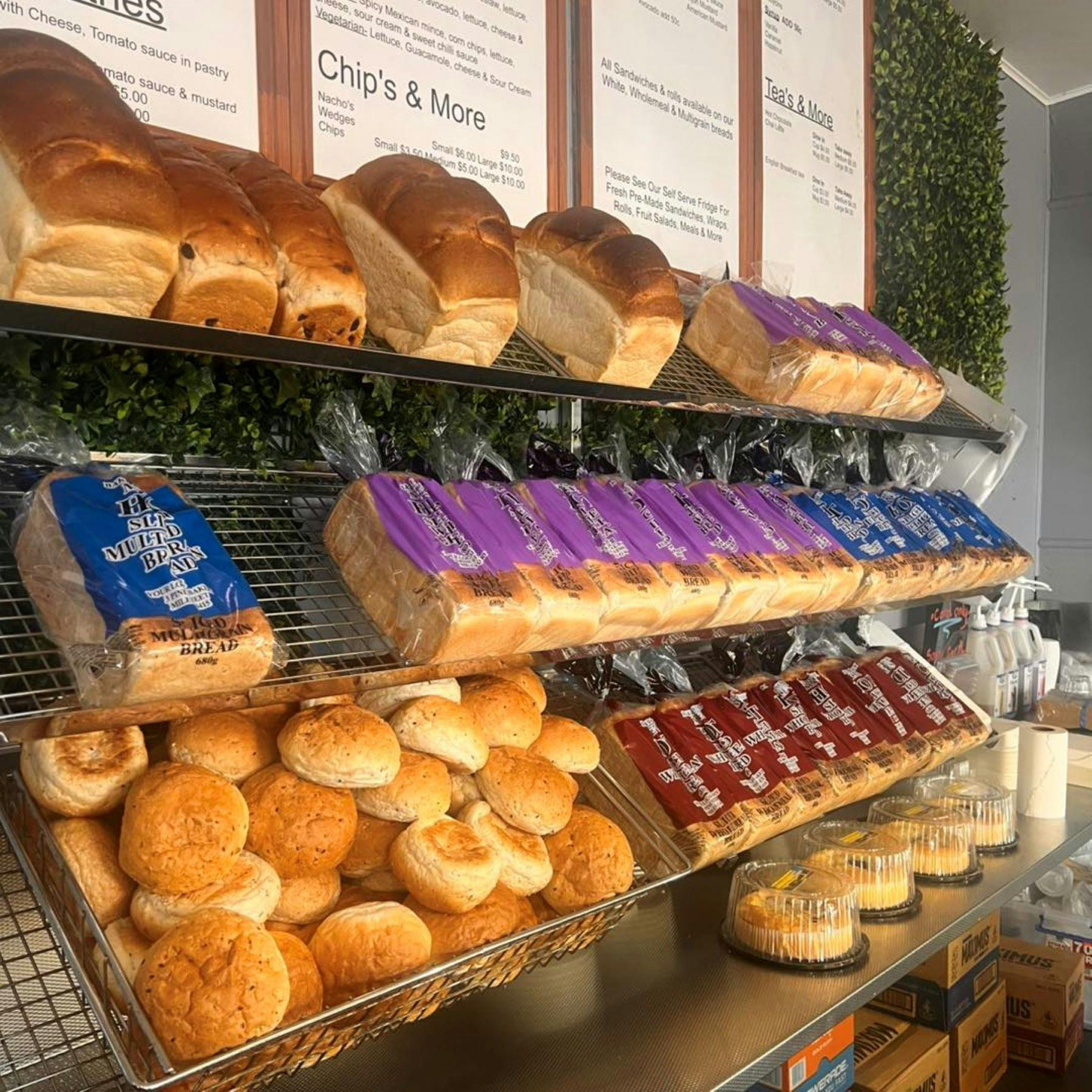 Fresh bread and breadrolls jus waiting to be purchased off the shelf.  Baked fresh daily.