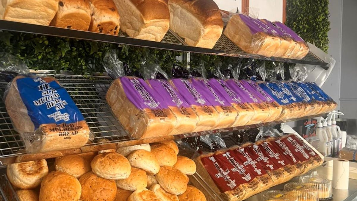 Fresh bread and breadrolls jus waiting to be purchased off the shelf.  Baked fresh daily.