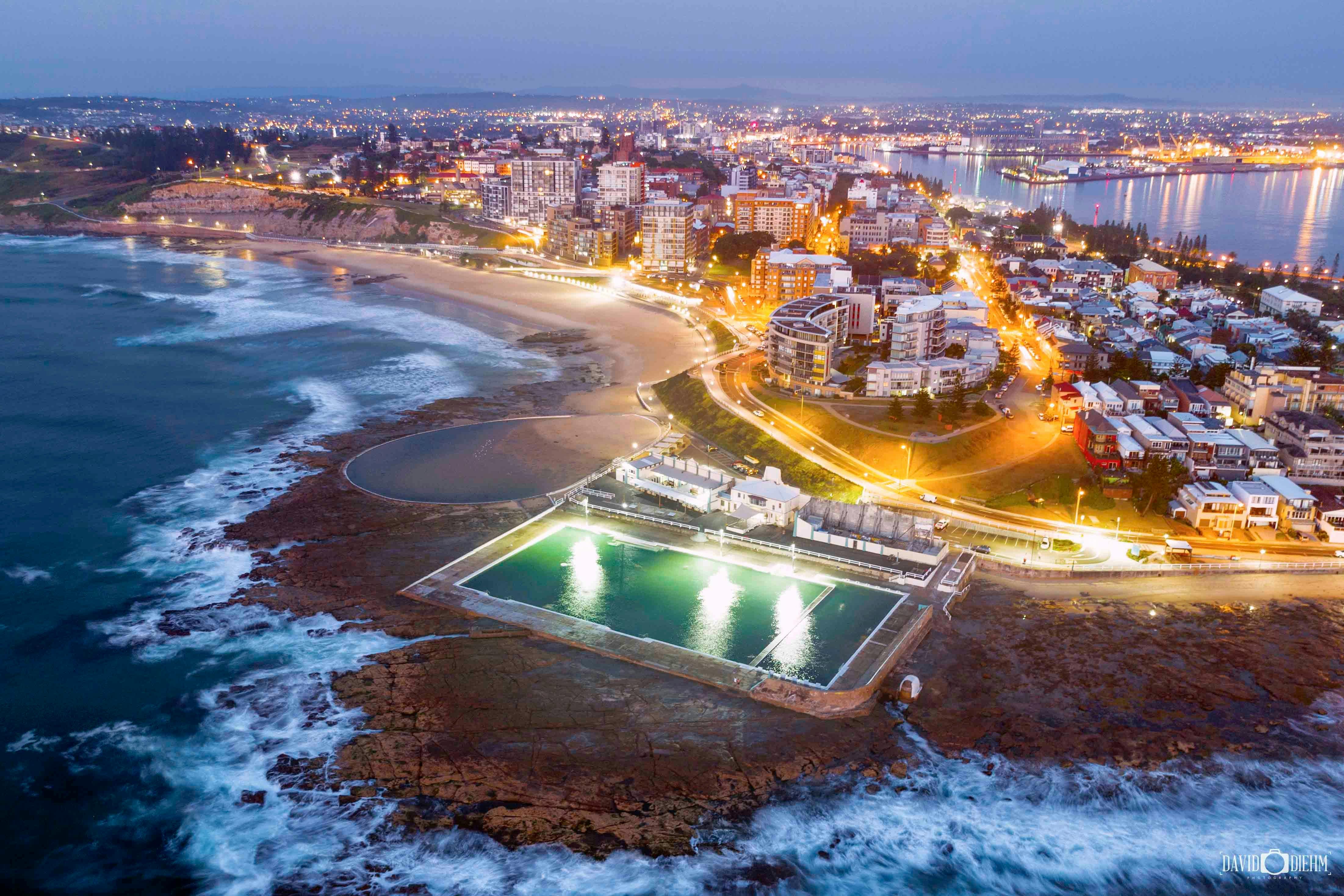 Newcastle illuminated after dark, captured from above with glowing city lights