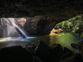 Natural Bridge (rock arch) with waterfall.