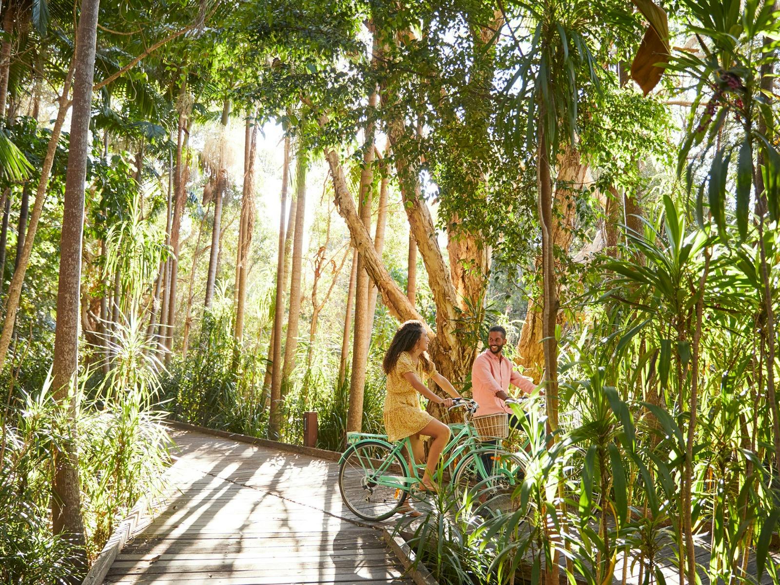 Guests cycling through Crystalbrook Byron’s lush rainforest setting