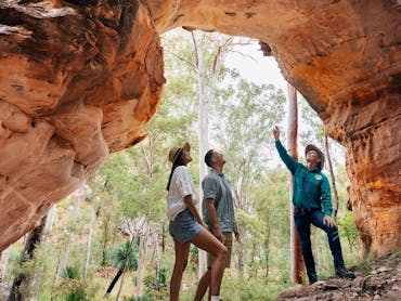 Three people at Arch Rock, Carnarvon Ranges Three people at Arch Rock, Carnarvon Ranges