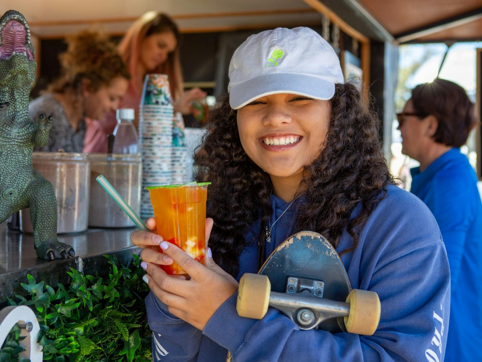Young girl with drink at market stall