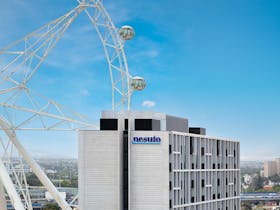 Nesuto Docklands building exterior with the Melbourne Star Observation Wheel in the background