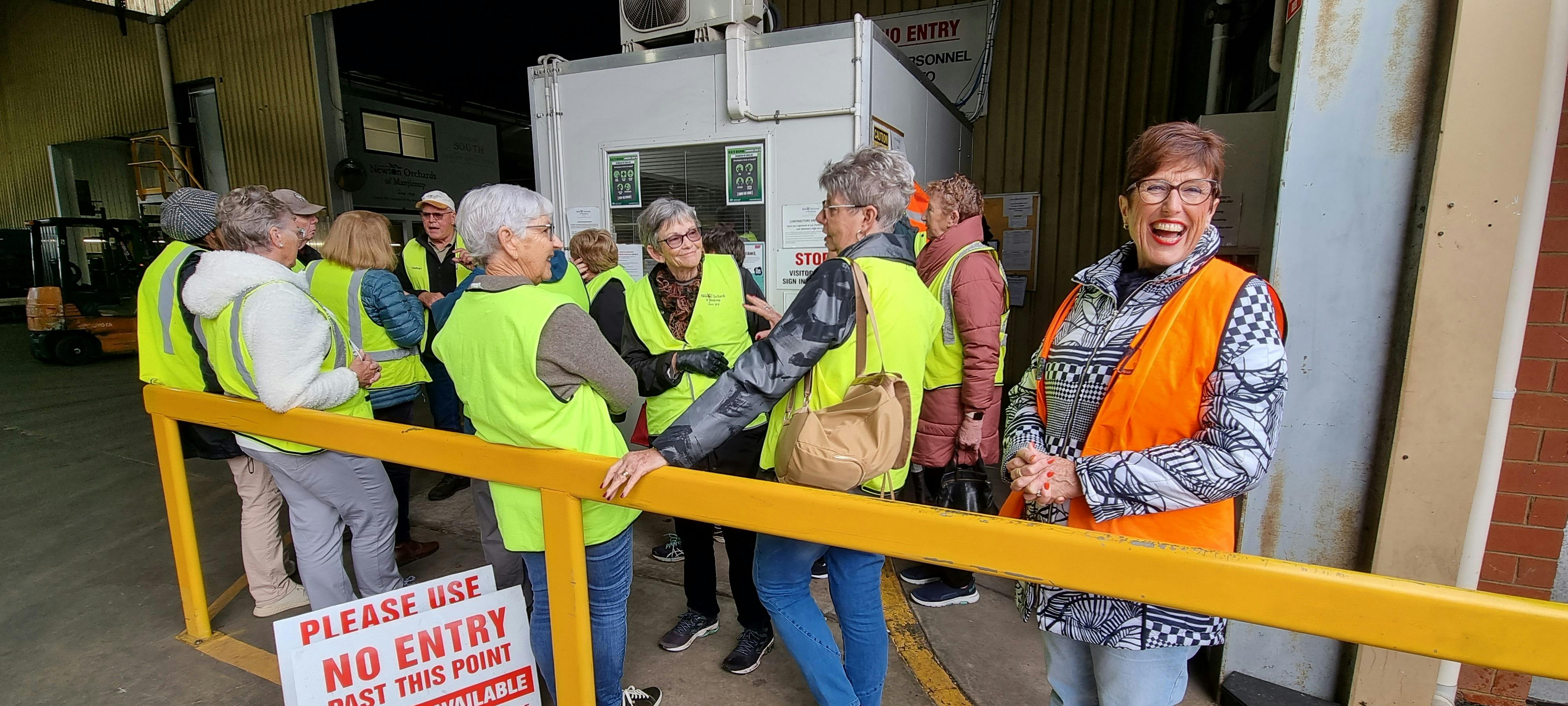 Travel with Me group entering Newton Orchards Packing Shed