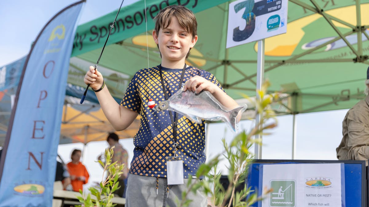 boy holding fish boy holding fish