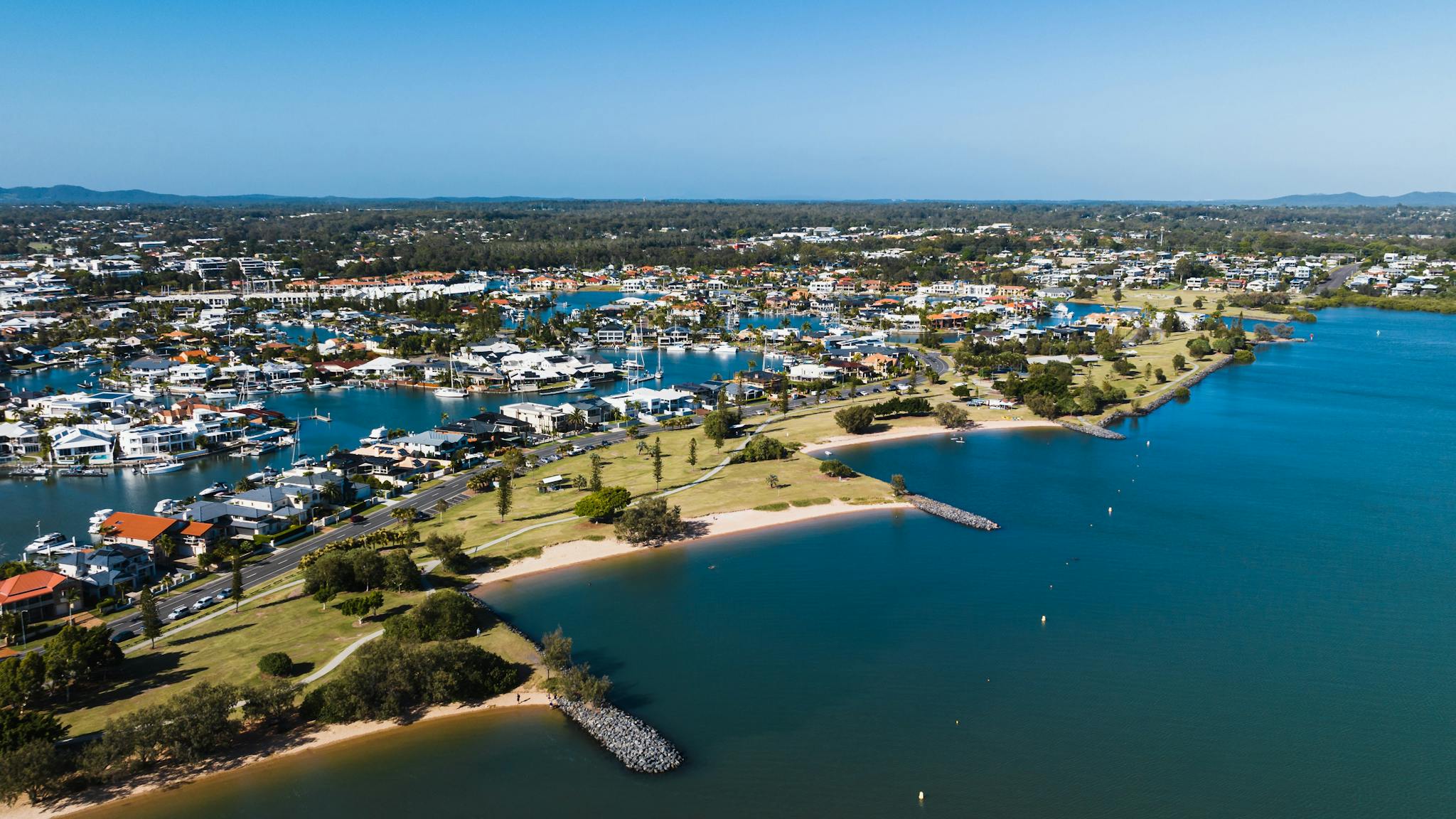 Aerial view of Raby Bay Foreshore Park, surrounded by housing, clear blue skies and canals. Aerial view of Raby Bay Foreshore Park, surrounded by housing, clear blue skies and canals.