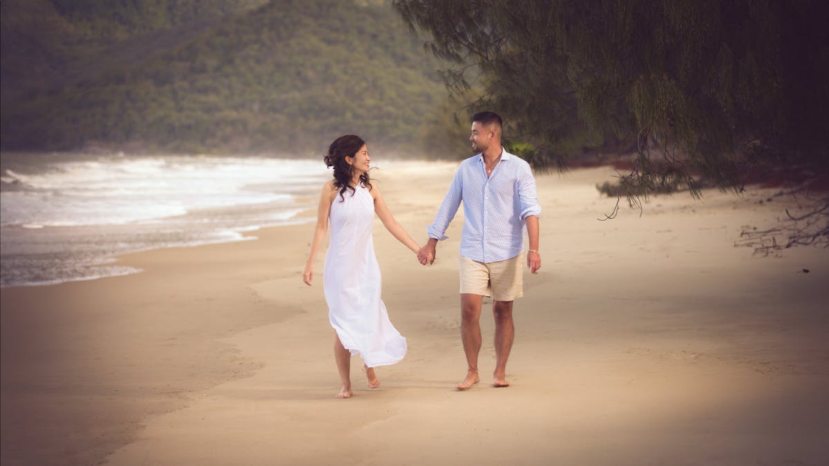 Couple walking in Port Douglas, QLD during a professional holiday photography session.