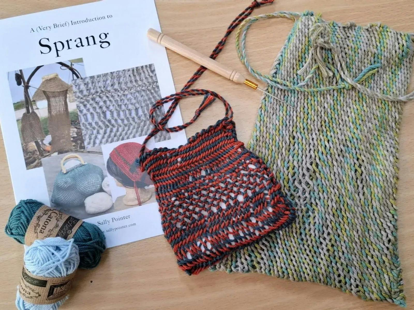 Two handwoven bags with knitting needles and a book