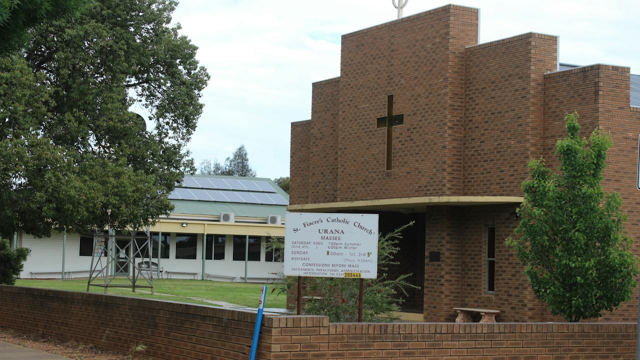 The brick fence and building of St Fiacres Roman Catholic Church in Urana.