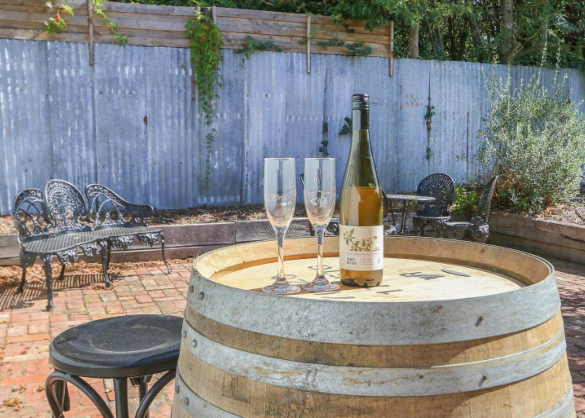patio area with wine barrels and wine flutes