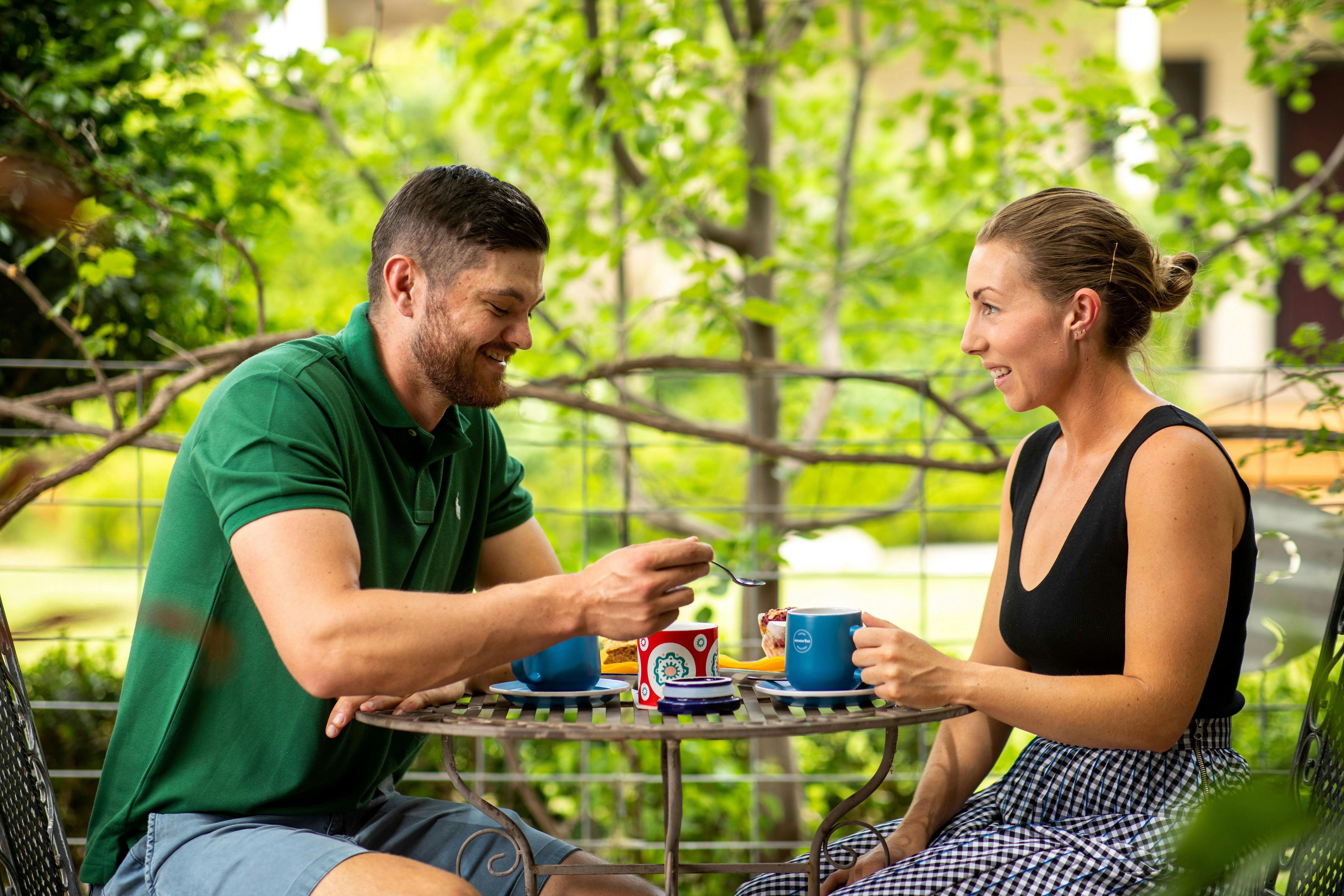 couple enjoying coffee amongst the nursery plants