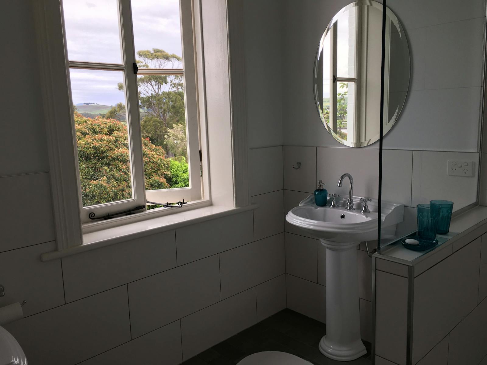 Bathroom with a view garden and distant hills