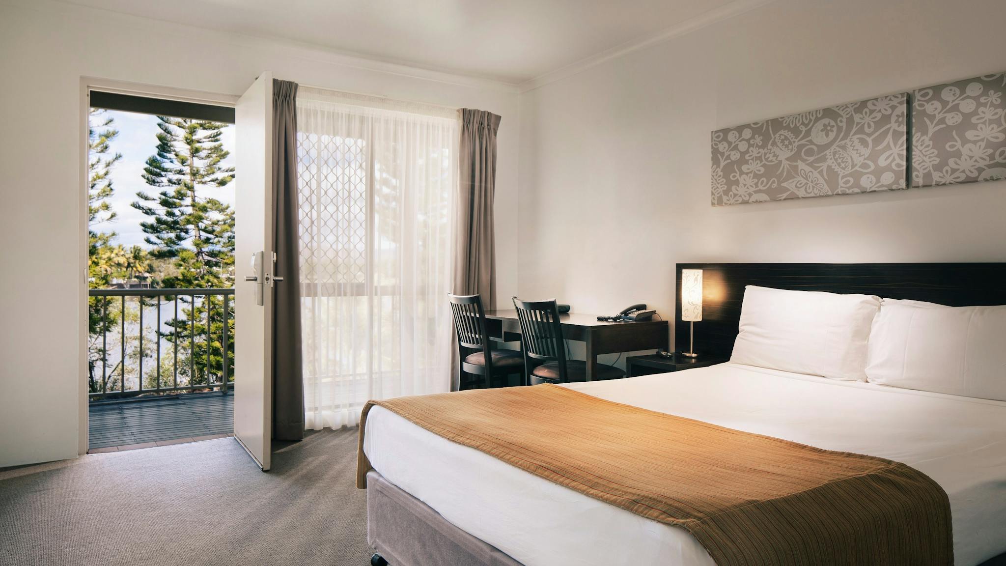 Hotel room with a queen bed Hotel room with a queen bed