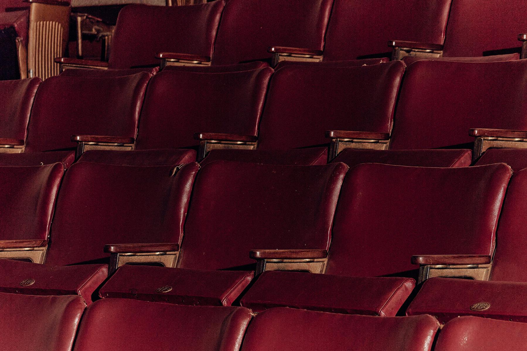 Rows of deep red leather chairs.
