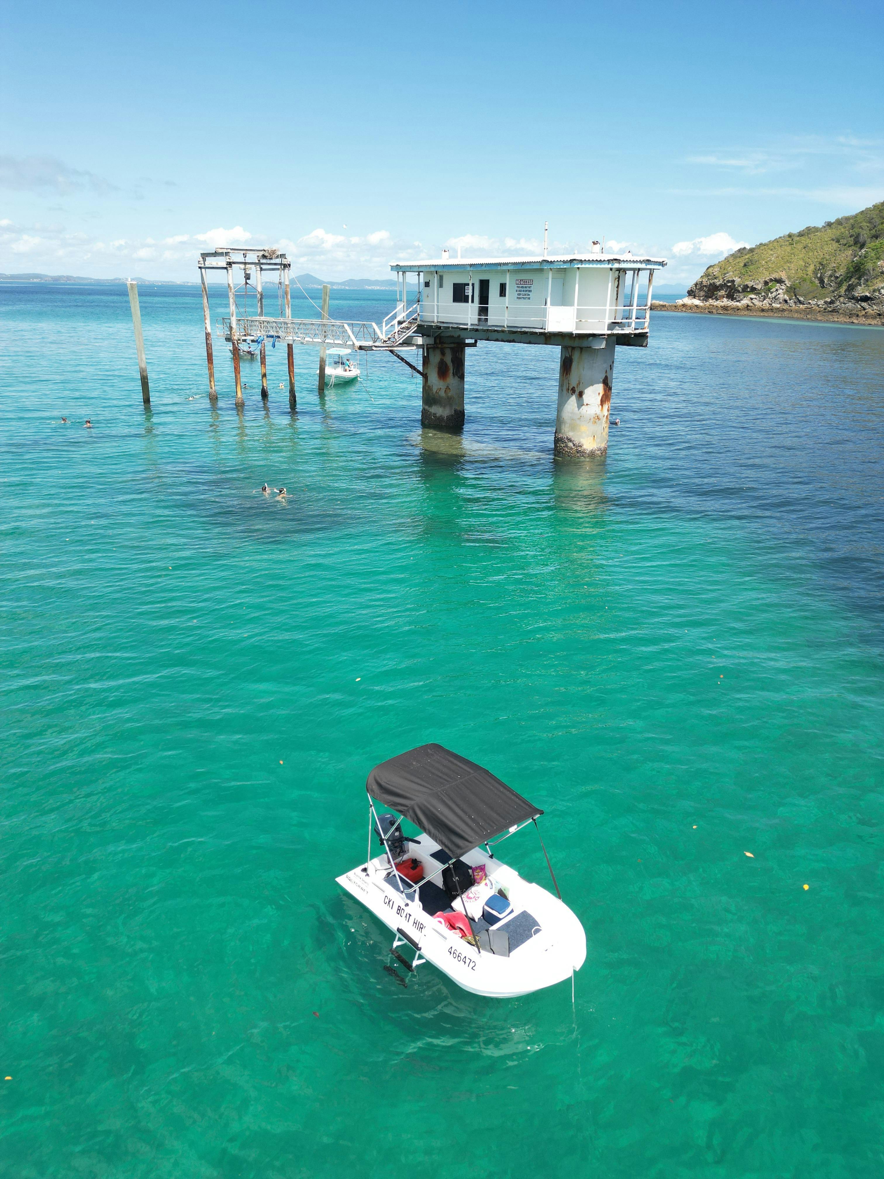 Self-drive boat anchored near the old pier on Great Keppel Island, Queensland.