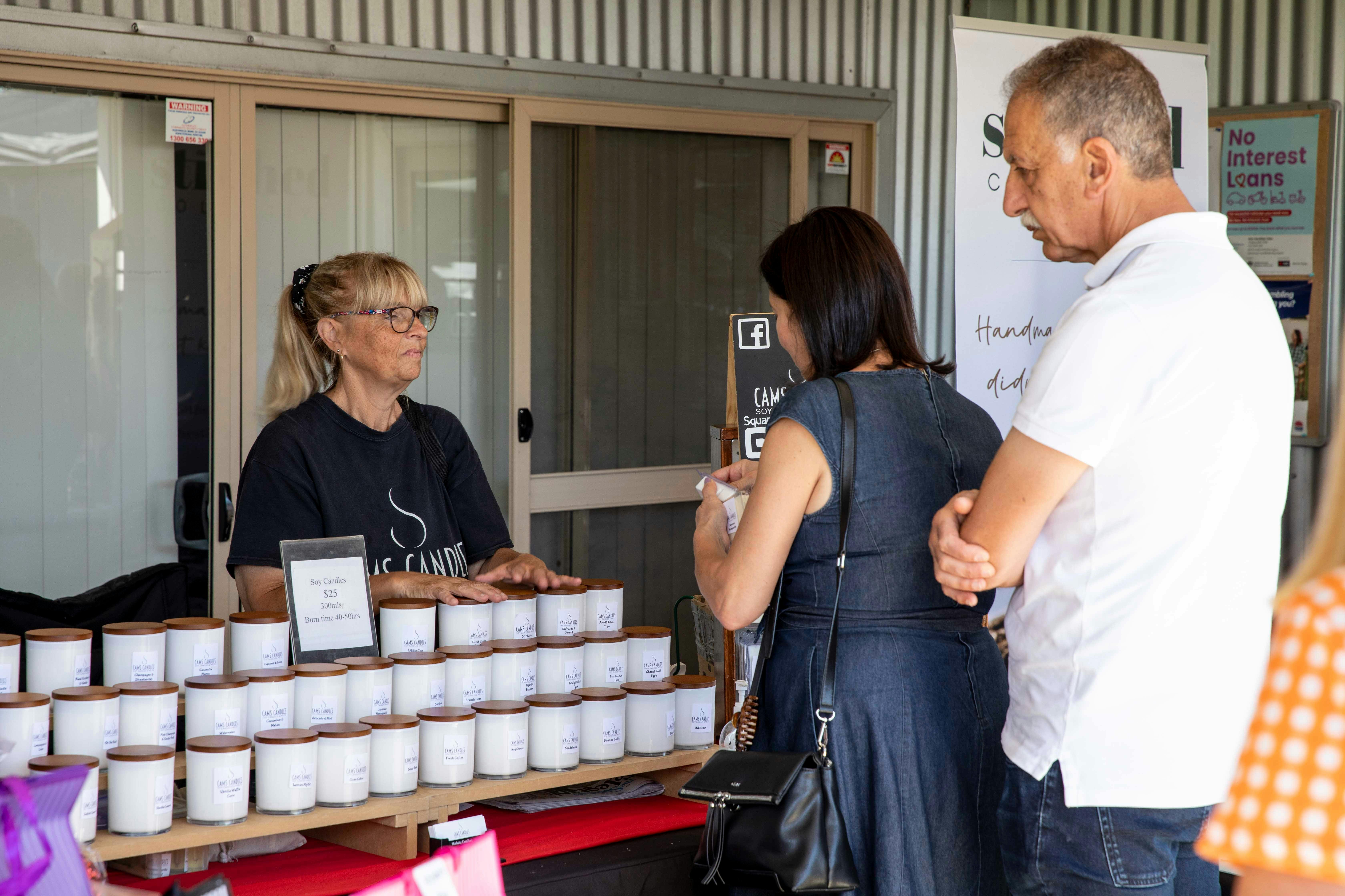 People browsing the candle stall Cams Candles