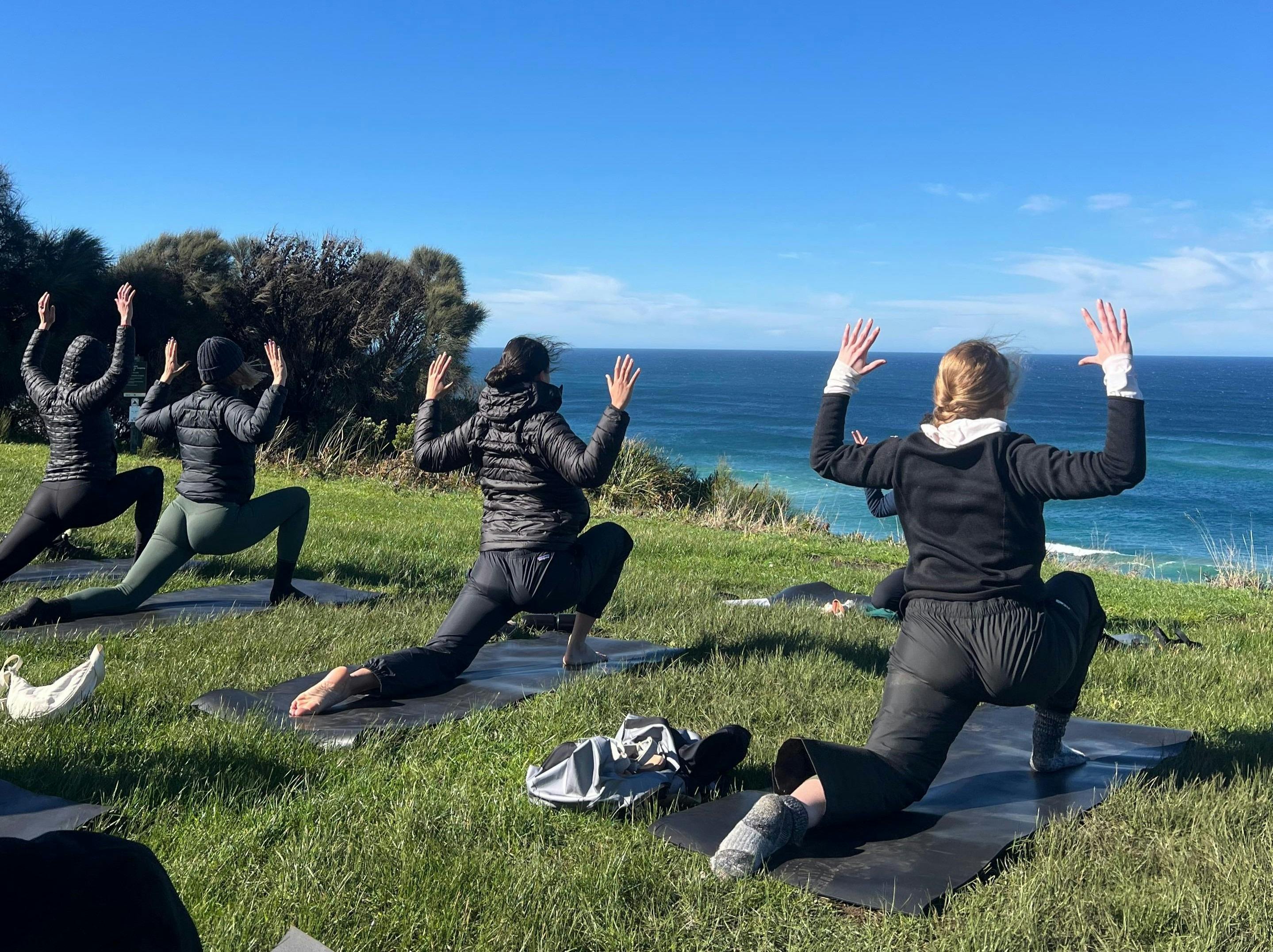 Yoga on a retreat by the sea on lush grass
