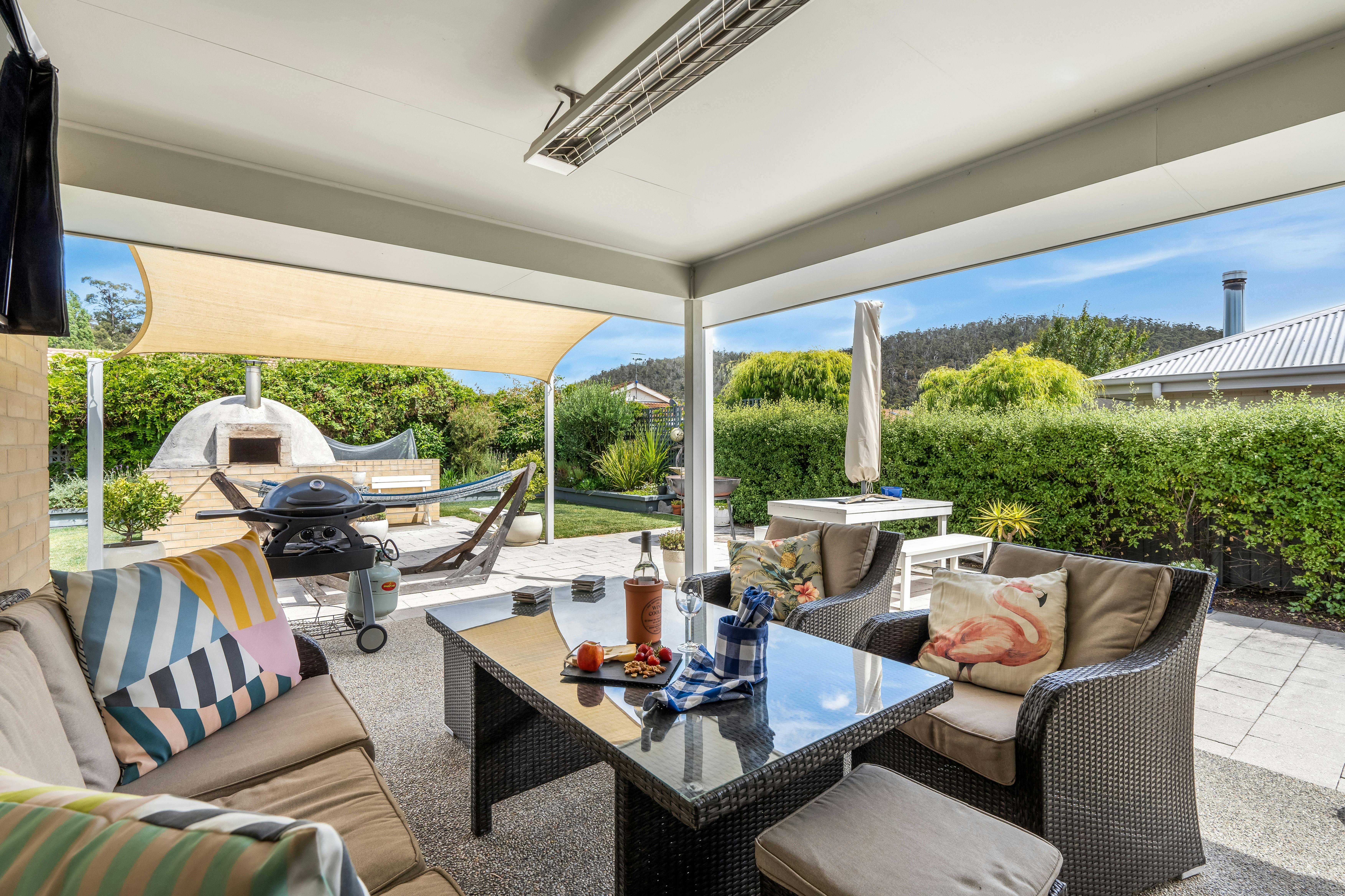 Photo of the outdoor / al fresco area with wood fired oven in background