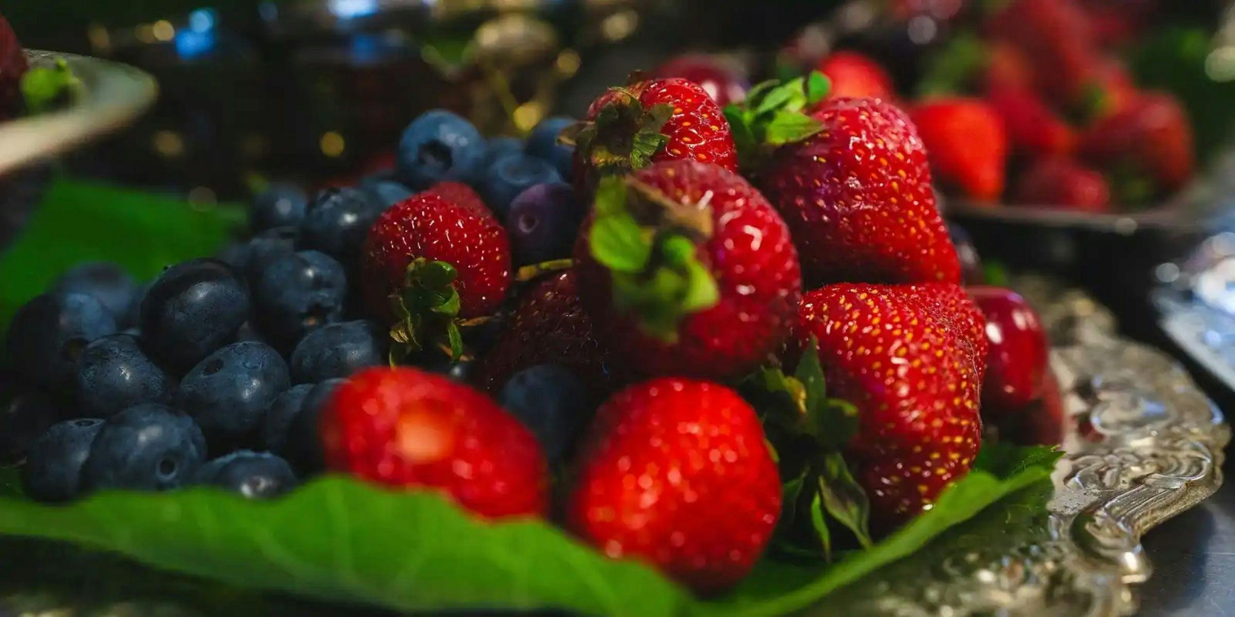 A plate of blueberries and strawberries