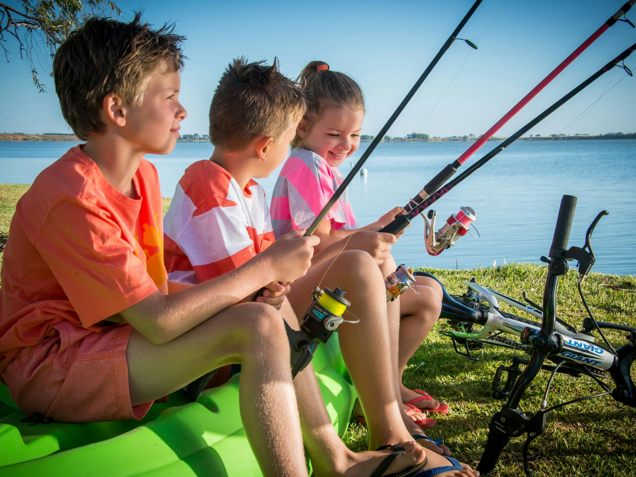 3 children fishing on the shore of Lake Charm