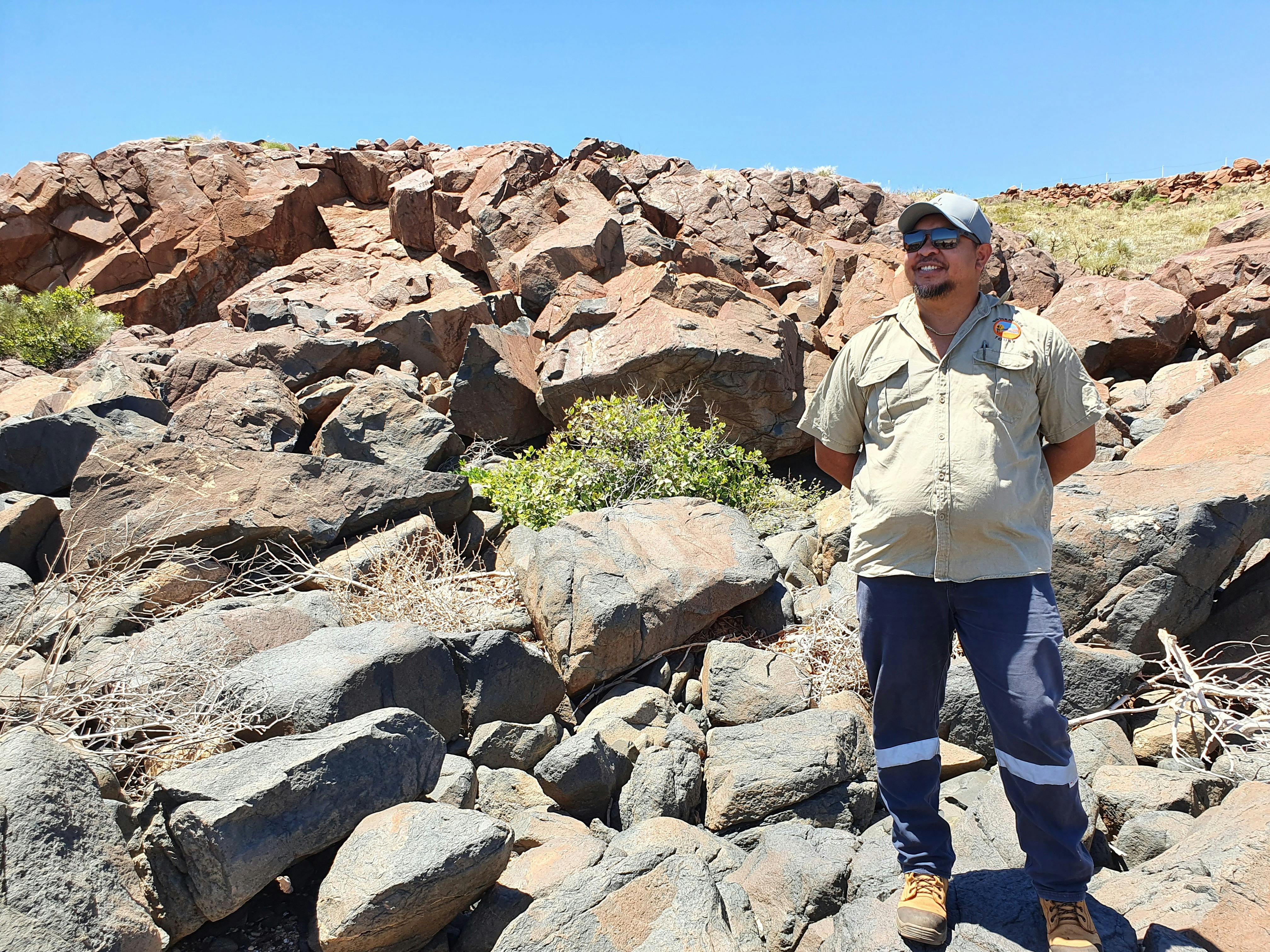 Clinton Walker in front of rock art at Settler's Beach